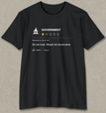 A black short-sleeve t-shirt with a white graphic print resembling a review rating for 'GOVERNMENT', featuring a star rating of 1 out of 4 and the text 'Do not trust. Would not recommend.