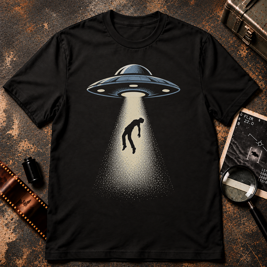 Retro UFO abduction design featuring a blue-grey flying saucer with a cream tractor beam lifting a limp human silhouette against a black background.