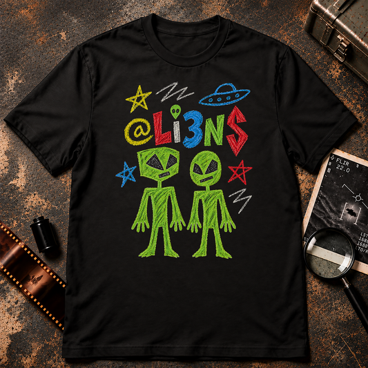 Crayon-style alien drawing shirt featuring two crudely drawn green aliens beneath colorful @Li3NS lettering, with hand-drawn stars and a UFO on black.