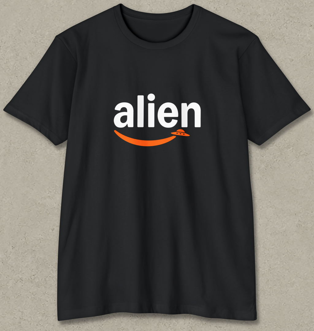 A black short-sleeve t-shirt with a graphic on the chest featuring the word 'alien' in white lowercase letters and an orange curved smile underneath, displayed against a textured gray background.