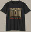 A black short-sleeve crewneck t-shirt with a graphic print on the front. The graphic features a stylized barcode in gold and brown tones with a dark silhouette of a person inside, accompanied by the text 'CITIZEN NUMBER' in gold and 'PROPERTY OF THE STATE' in red.