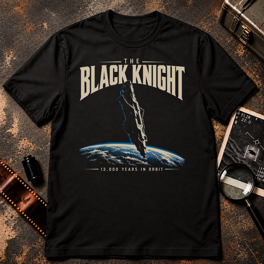 Black Knight Satellite T-shirt graphic featuring a mysterious ancient alien spacecraft above Earth with retro cream lettering and 13,000 Years in Orbit text.