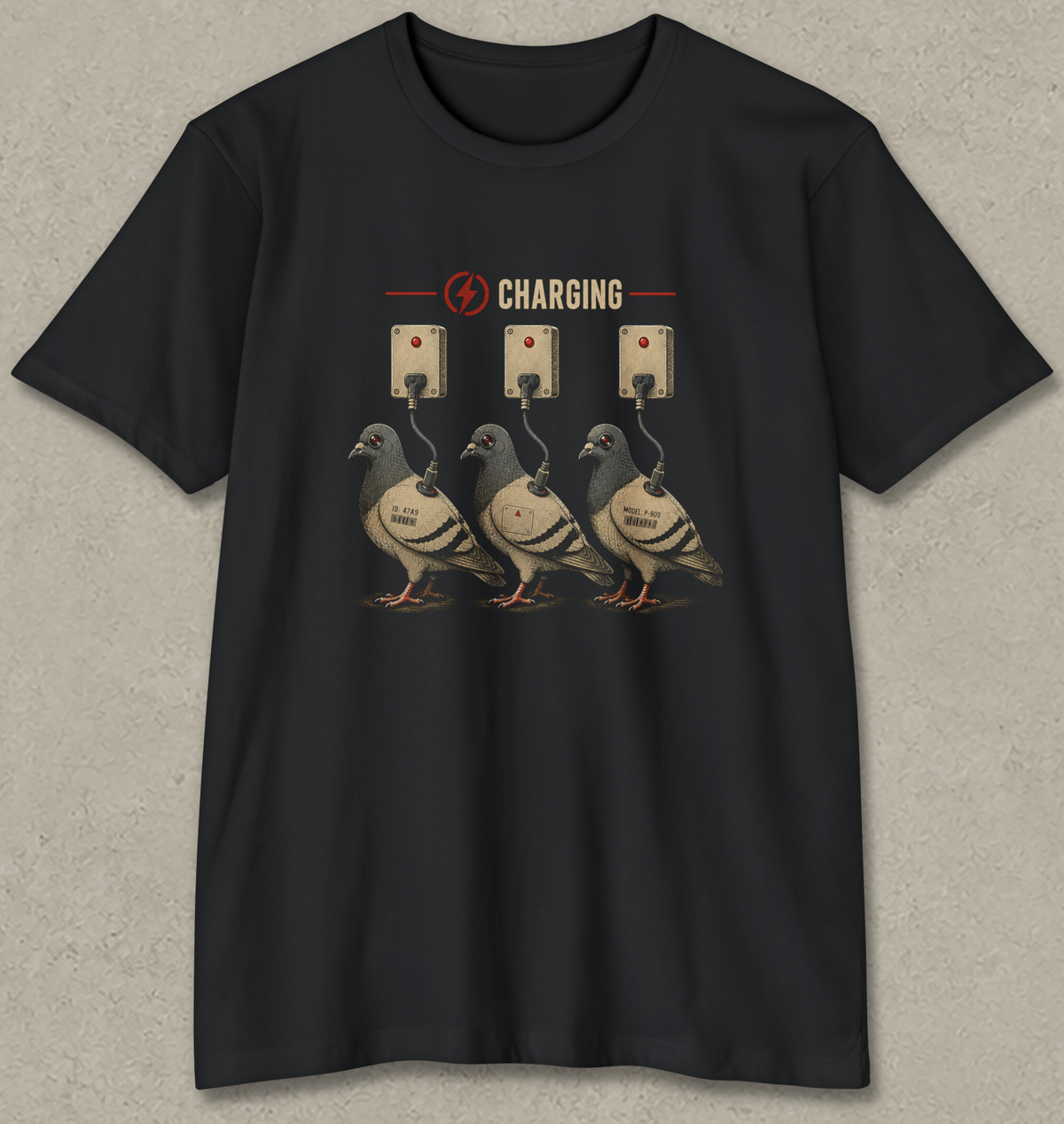 A black short-sleeve crewneck t-shirt with a graphic print of three pigeons charging at wall outlets, displayed flat against a textured gray background.