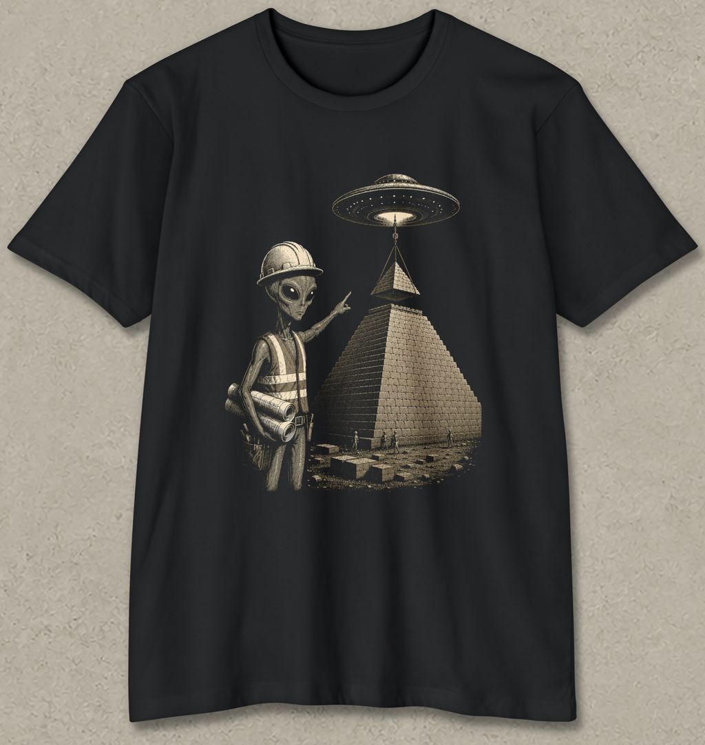 A black short-sleeve crewneck t-shirt featuring a graphic print of a gray alien wearing a construction helmet and safety vest next to a pyramid with a UFO overhead, displayed on a textured gray background.