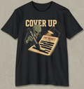 A black short-sleeve crewneck t-shirt with a vintage-style graphic on the front. The graphic features the words 'COVER UP' in beige, an alien in a suit holding a pen labeled 'OFFICIAL NEGATIVE', and a document labeled 'TOP SECRET'.