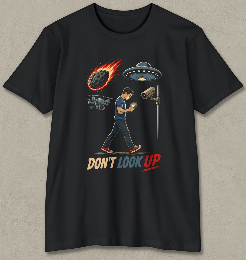 A black short-sleeve t-shirt with a graphic print of a man walking under a security camera and UFO, with a burning rocket and the text 'DON'T LOOK UP' in red and beige.