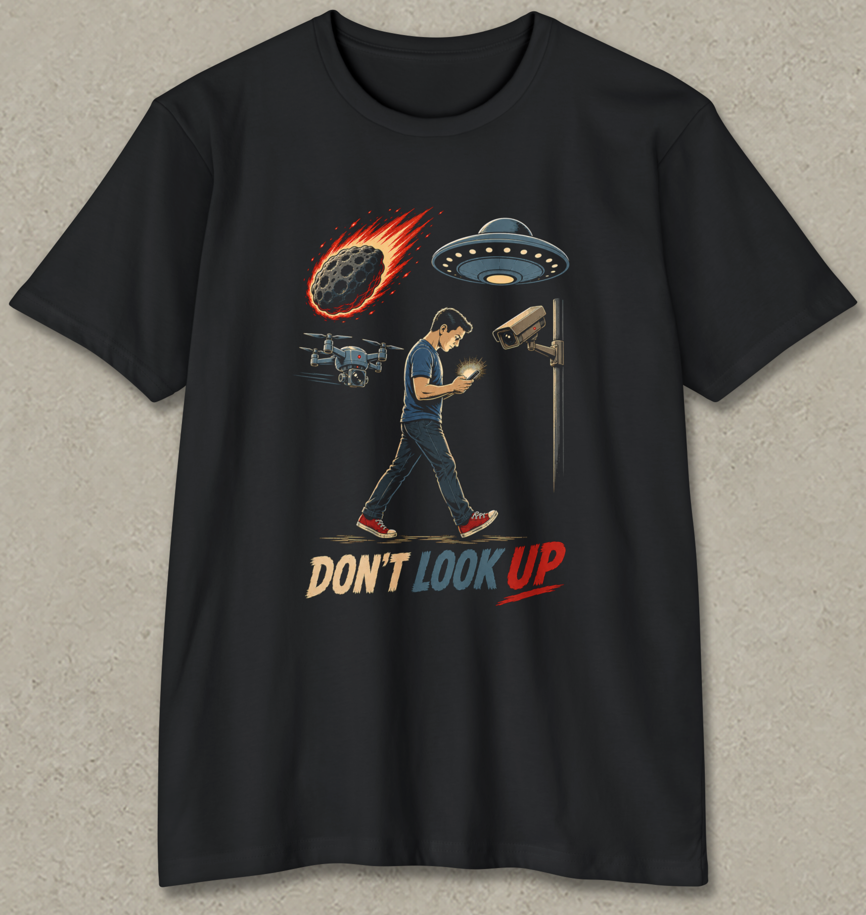 A black short-sleeve t-shirt with a graphic print of a man walking under a security camera and UFO, with a burning rocket and the text 'DON'T LOOK UP' in red and beige.