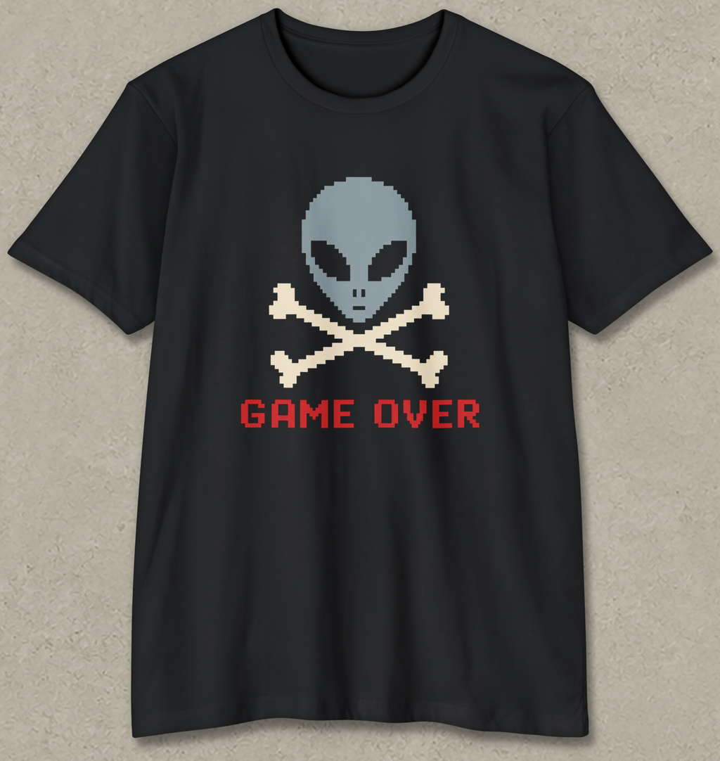 A black short-sleeve t-shirt with a pixel-art graphic of a gray alien skull and crossbones above the red text 'GAME OVER' on a textured gray background.
