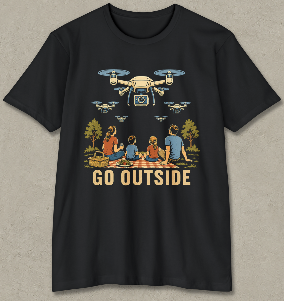 A black short-sleeve crewneck t-shirt with a graphic print of a family picnic under drones, featuring the text 'GO OUTSIDE' in a retro font.