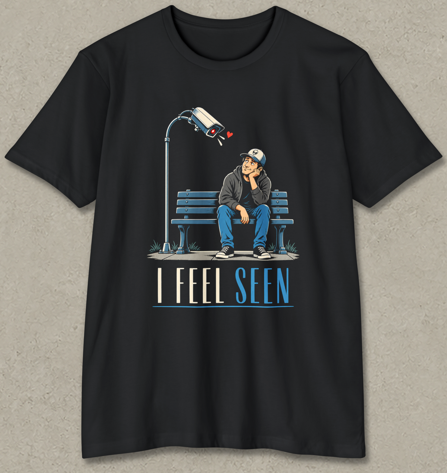 I FEEL SEEN shirt design featuring a man sitting on a park bench gazing affectionately at a surveillance camera leaning toward him with a red heart.