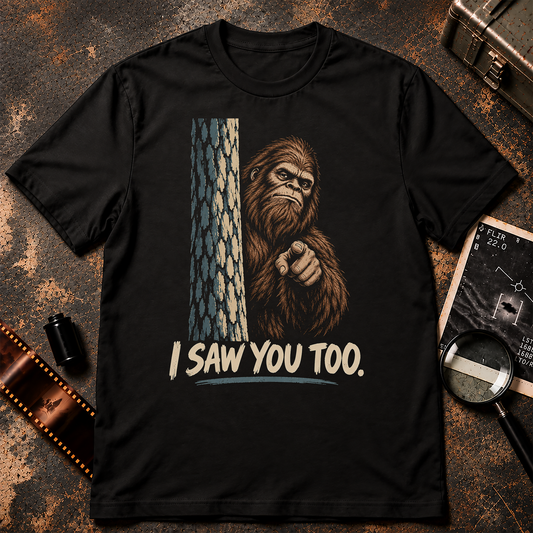 Bigfoot peeking from behind a tree and pointing at the viewer above the words I Saw You Too.