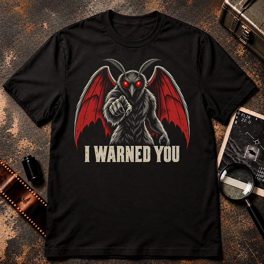 Red-eyed Mothman with large red wings pointing toward the viewer above distressed cream text reading I Warned You on a black background.