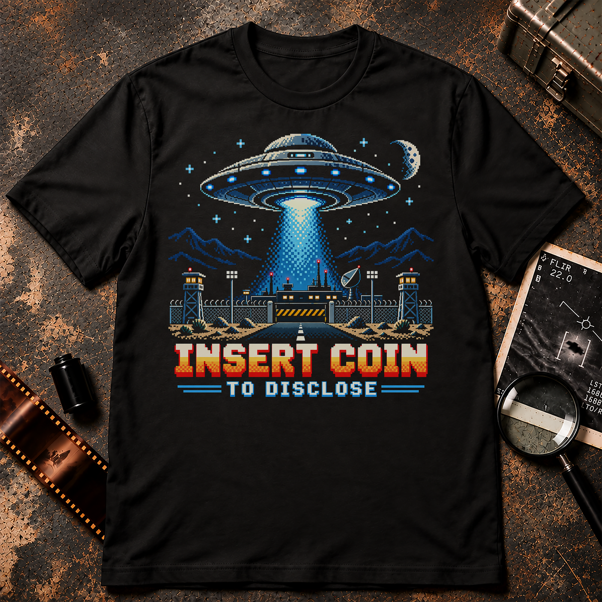 Insert Coin UFO Shirt with retro pixel UFO hovering over a secret desert military base