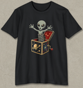 A black short-sleeve crewneck t-shirt featuring a graphic of a grey alien popping out of a juggling box filled with space-themed illustrations, displayed on a textured light gray background.