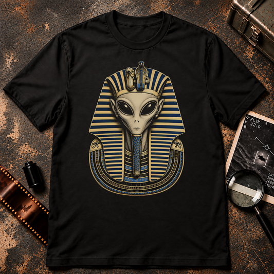 Grey alien depicted as an ancient Egyptian pharaoh wearing an ornate blue and cream striped headdress with cobra details.