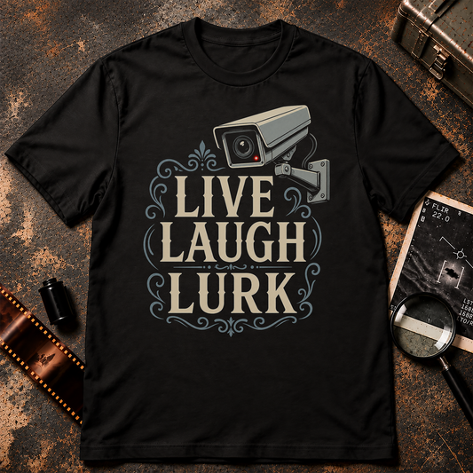 LIVE LAUGH LURK shirt design featuring vintage cream lettering, decorative blue-gray flourishes, and a surveillance security camera with a red indicator light.