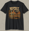 A black short-sleeve crewneck t-shirt with a retro-style graphic on the front. The graphic features two green aliens standing next to a wooden sign that reads 'AREA 51 VISITORS WELCOME' under a sign reading 'RESPECT THE LOCALS'.