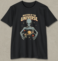 A black short-sleeve crewneck t-shirt with a retro sci-fi graphic of a gray alien holding planets, with the text 'MASTERS OF THE UNIVERSE' above it, displayed on a textured gray background.