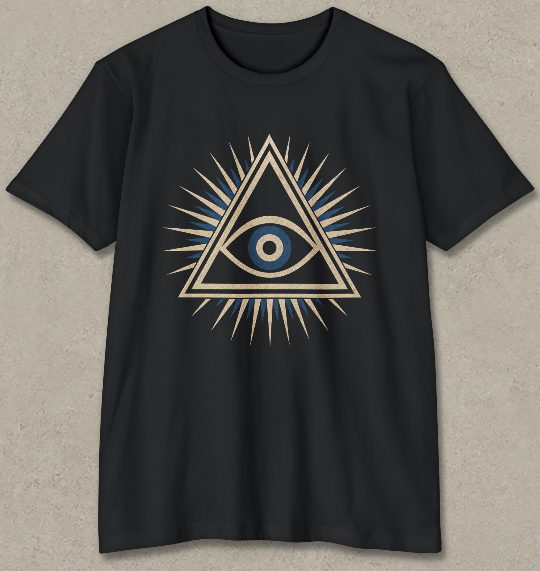 A black short-sleeve crewneck t-shirt featuring a central graphic of an all-seeing eye inside a triangle with radiating spikes, detailed in gold, blue, and white, displayed against a textured gray background.