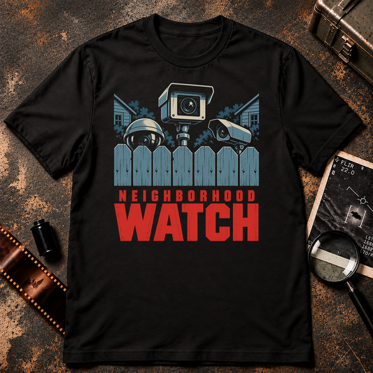 NEIGHBORHOOD WATCH shirt design featuring three surveillance cameras peering over a blue-grey suburban picket fence with bold red text.