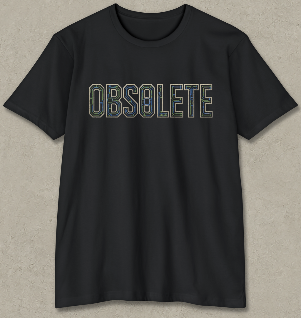 A black short-sleeve crewneck t-shirt with the word 'OBSOLETE' printed across the chest in a retro, outlined font. The letters are filled with a camouflage pattern in shades of green, blue, and brown.