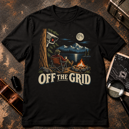 OFF THE GRID shirt design featuring a camper by a moonlit lake and campfire while a red-lensed surveillance camera watches from behind a tree.