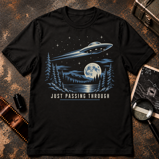 Just Passing Through UFO T-Shirt design featuring a retro flying saucer streaking over a moonlit mountain lake and pine forest.