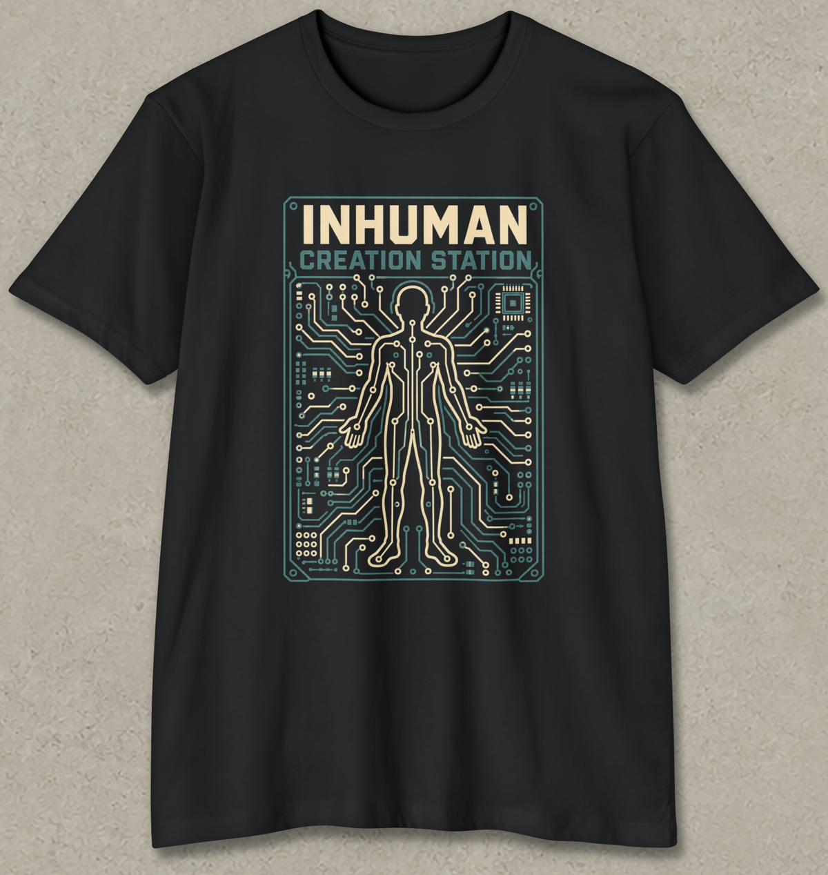 A black short-sleeve crewneck t-shirt with a graphic print on the front. The graphic features the text 'INHUMAN CREATION STATION' in beige and teal above a stylized human figure made of circuit board lines.