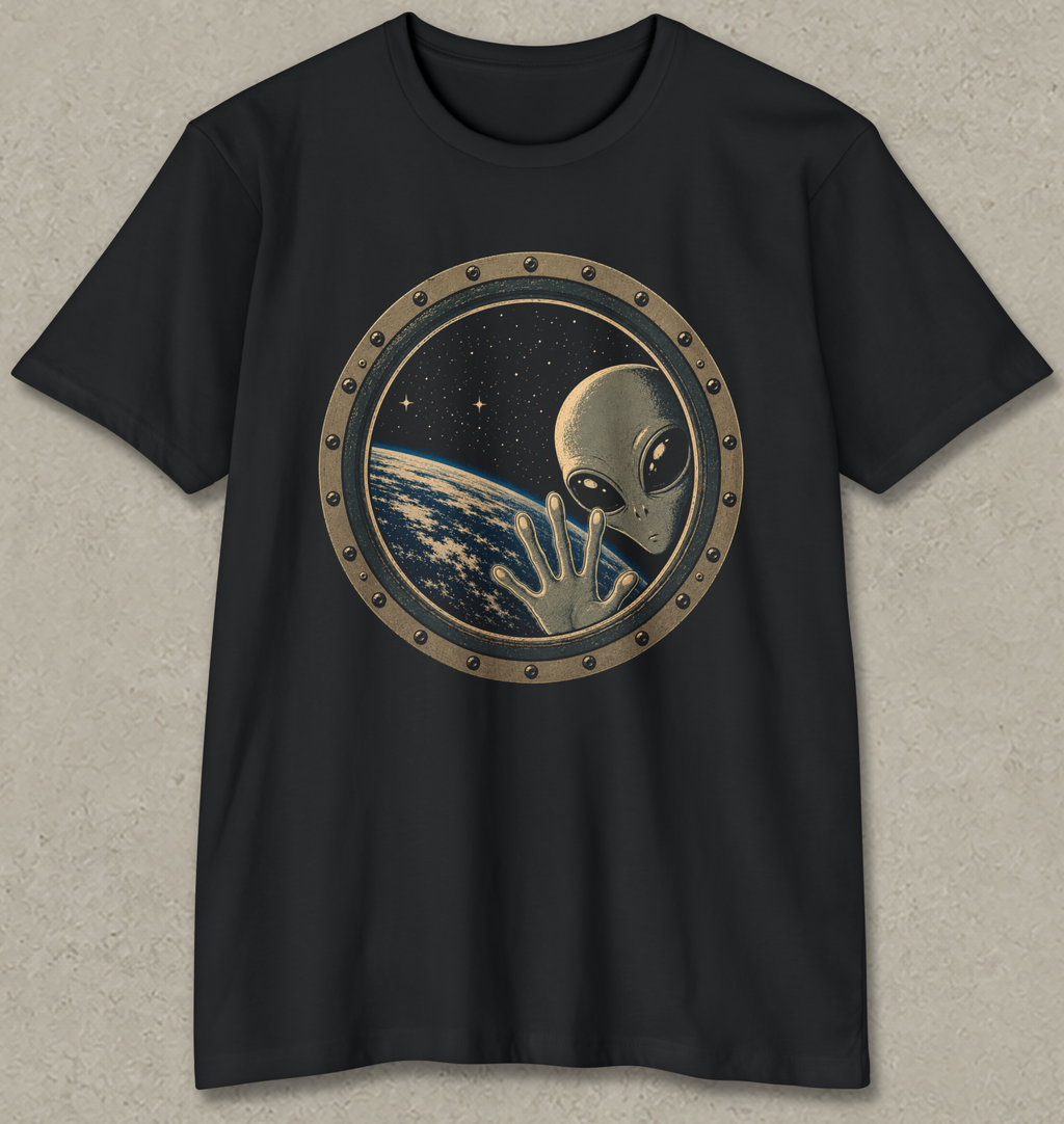 A black short-sleeve crewneck t-shirt featuring a circular graphic print of a classic silver-grey alien waving from space, with Earth visible in the background.