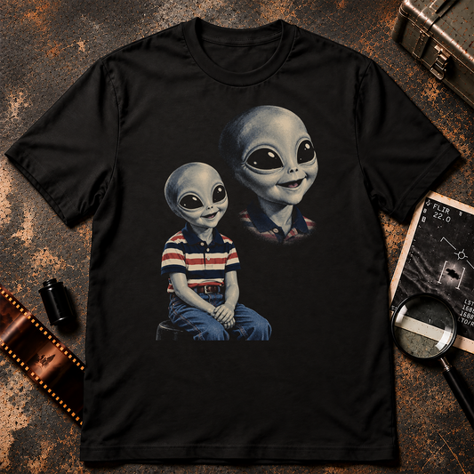 Retro 1980s portrait studio design featuring a smiling grey alien boy in a striped polo and jeans with an oversized floating alien portrait behind him.