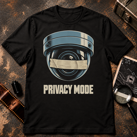 PRIVACY MODE shirt design featuring a blue-grey dome surveillance camera with cream tape covering the lens on a black background.