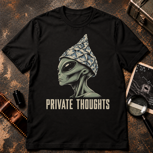 Private Thoughts tinfoil hat alien shirt graphic featuring a grey alien wearing a foil hat with distressed cream lettering