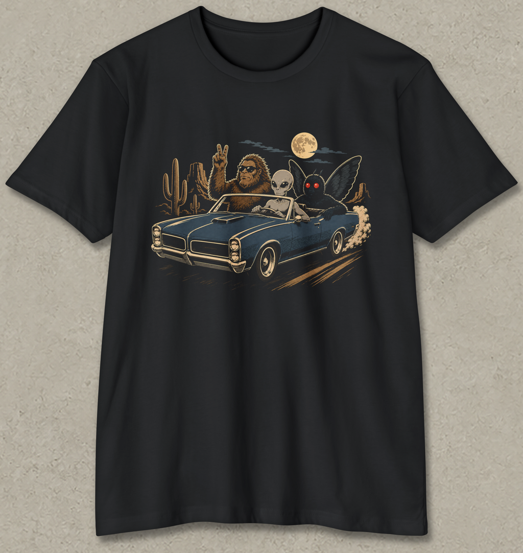 A black short-sleeve crewneck t-shirt with a graphic print of a blue convertible car driving through a desert at night, featuring a skeleton driver, a rabbit driver, and a full moon.