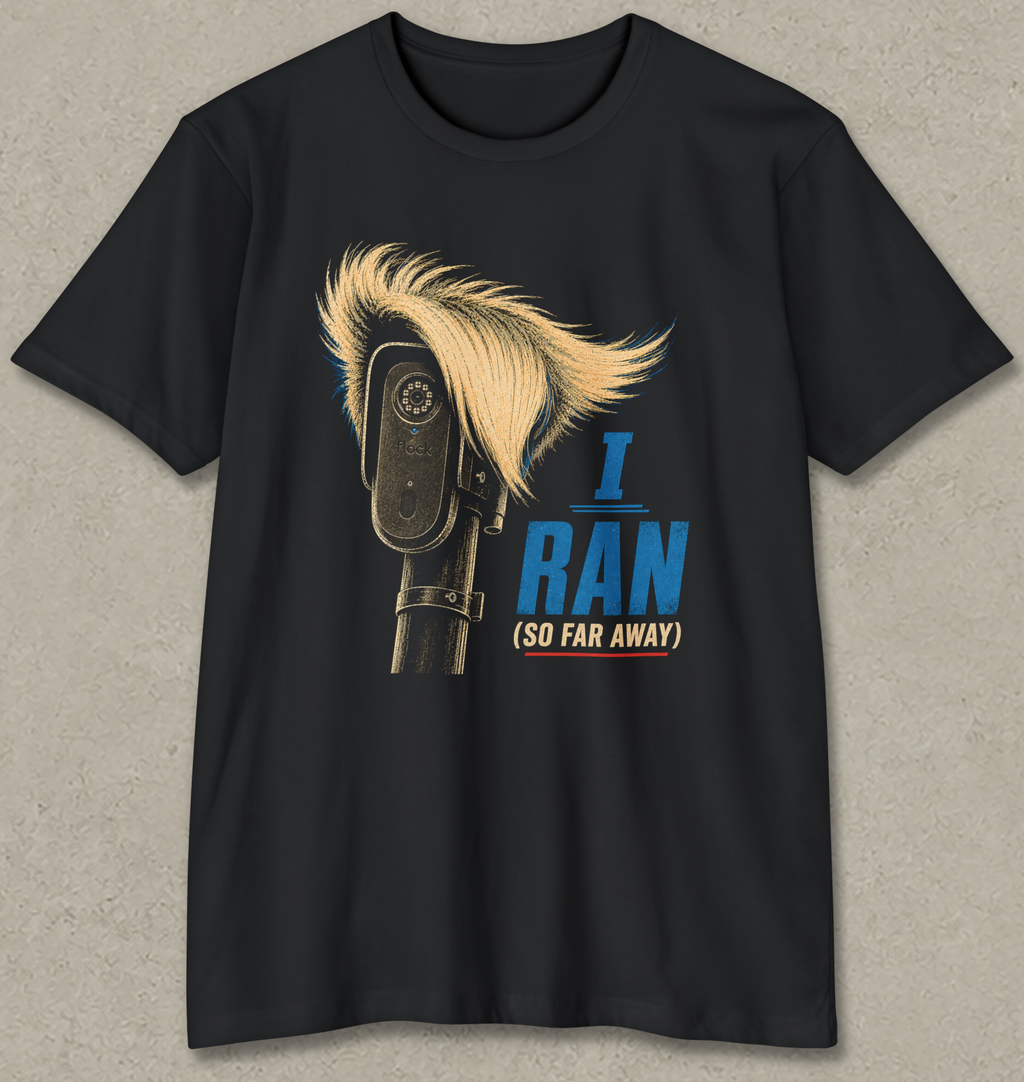 A black short-sleeve crewneck t-shirt featuring a graphic print of a revolver with a blonde mohawk and the text 'I RAN (SO FAR AWAY)' in blue and beige, displayed against a textured gray background.