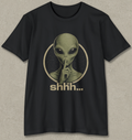 A black short-sleeve crewneck t-shirt featuring a vintage-style graphic of an alien with its finger to its lips inside a circle, with the word 'shhh.
