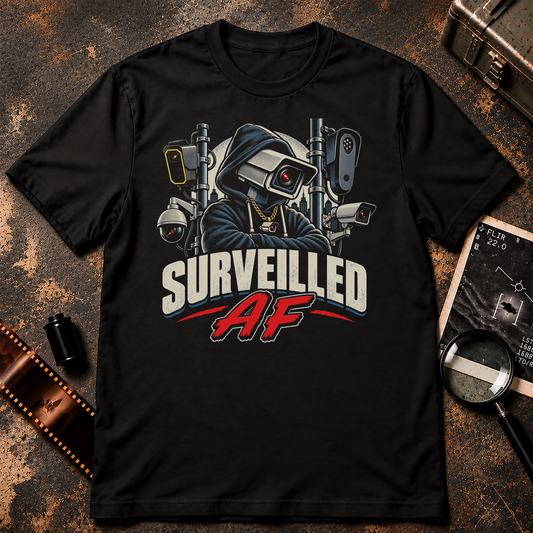 Surveilled AF shirt design featuring a hooded figure with a surveillance camera head surrounded by security cameras