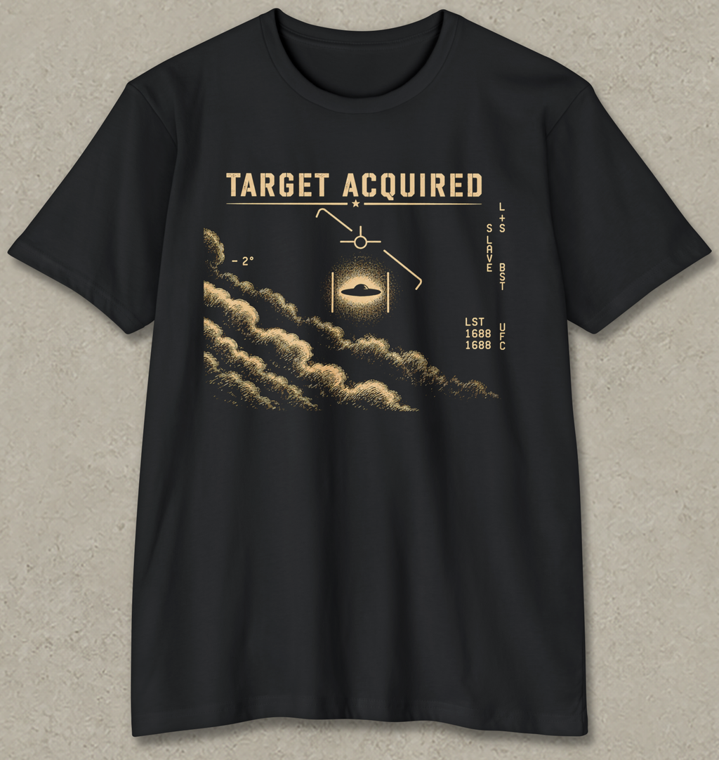 A black short-sleeve crewneck t-shirt with a detailed golden-brown graphic on the front. The graphic features the text 'TARGET ACQUIRED' above a stylized cloud pattern, a glowing aircraft silhouette, and navigation-style text on a textured gray background.