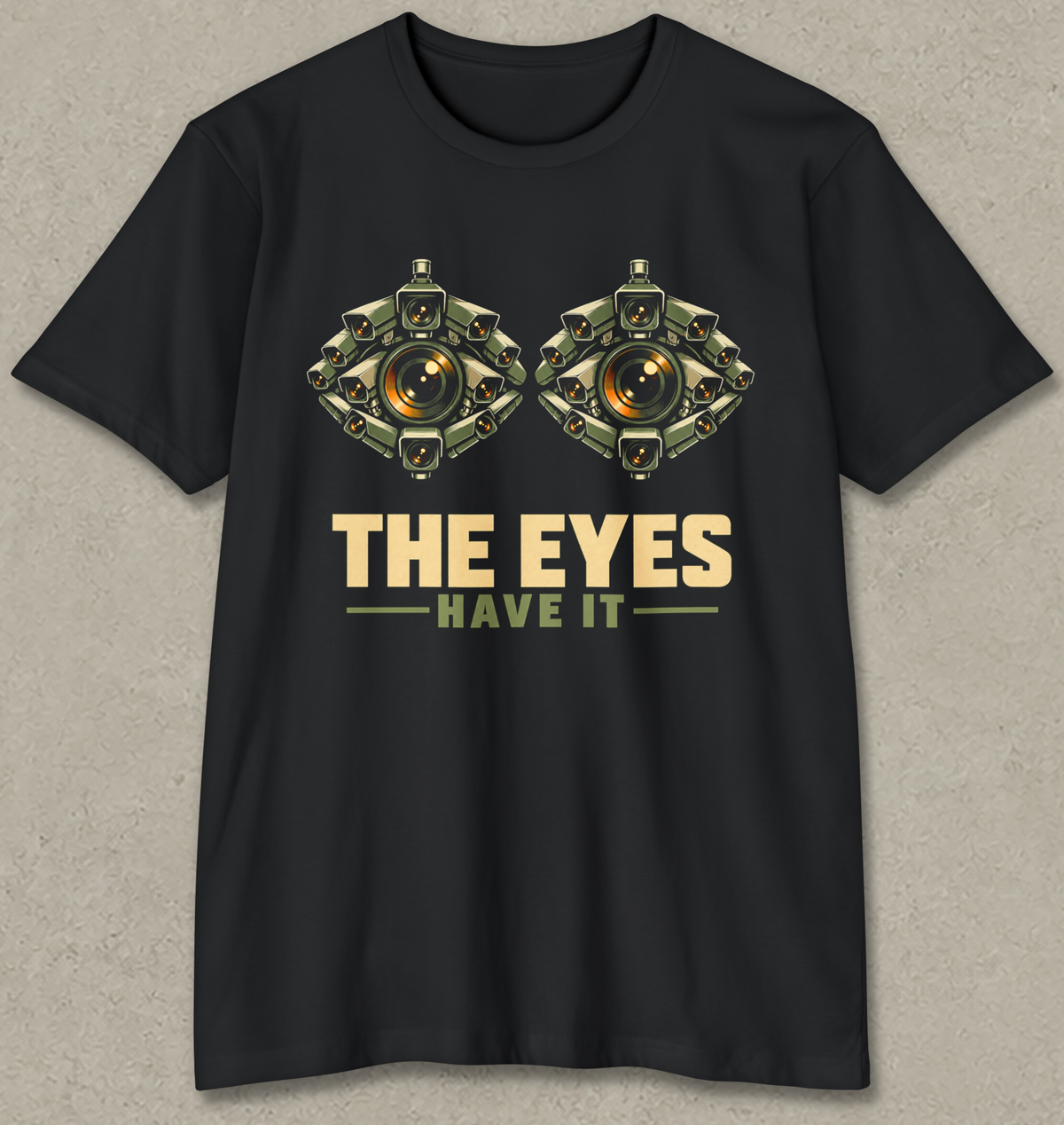 THE EYES HAVE IT shirt design featuring two giant eyes formed from clusters of olive surveillance cameras with glowing amber lenses on black.