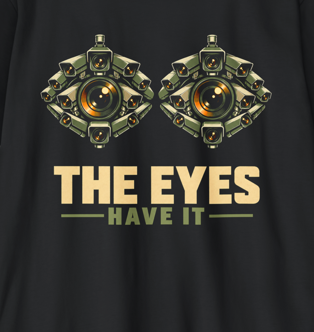 THE EYES HAVE IT shirt design featuring two giant eyes formed from clusters of olive surveillance cameras with glowing amber lenses on black.