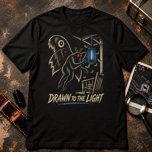 Drawn to the Light Mothman shirt design featuring the red-eyed cryptid flying toward a glowing bug zapper surrounded by moths.