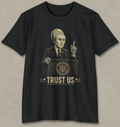 A black short-sleeve t-shirt with a vintage-style graphic of a man in a suit and cap speaking at a podium with the text 'TRUST US' and a U.S.