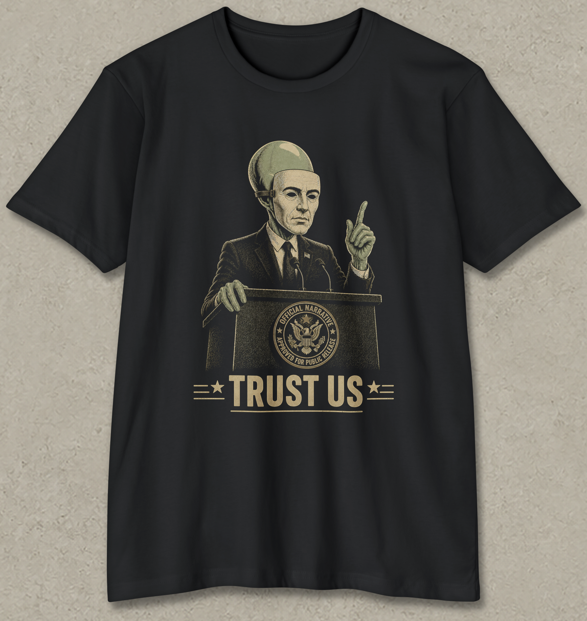 A black short-sleeve t-shirt with a vintage-style graphic of a man in a suit and cap speaking at a podium with the text 'TRUST US' and a U.S.