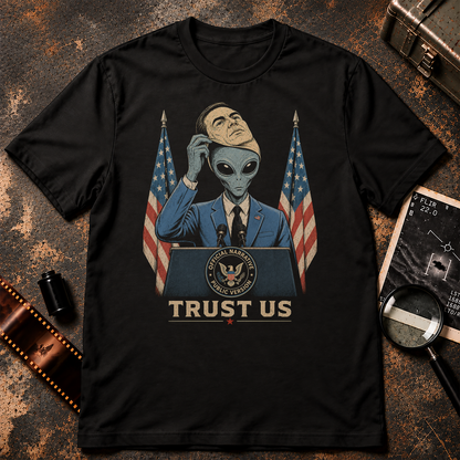 Retro conspiracy graphic of a grey alien in a blue suit standing behind a government-style podium between American flags, lifting a human face mask from its head. The podium seal reads “Official Narrative Public Version,” with distressed cream text below reading “TRUST US.”