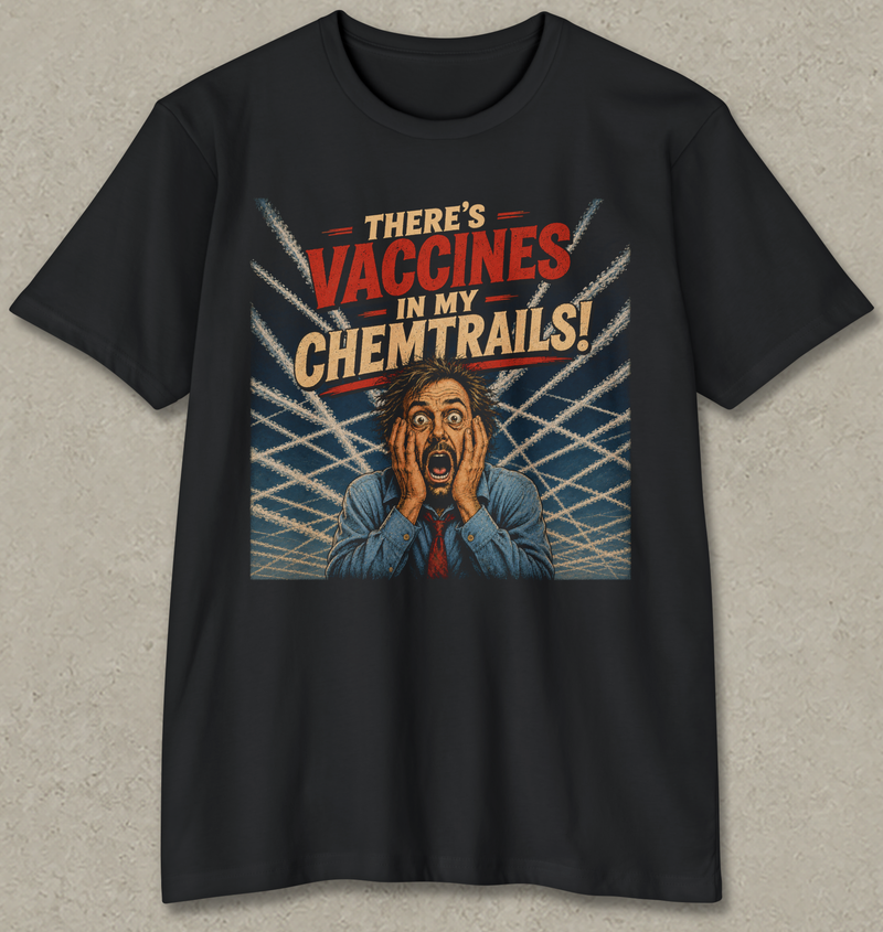 A black short-sleeve crewneck t-shirt with a graphic print on the front. The graphic features the text 'THERE'S VACCINES IN MY CHEMTRAILS!' in red and beige lettering, above an illustration of a shocked man in a blue suit holding his face, set against a background of white airplane trails on a blue sky.