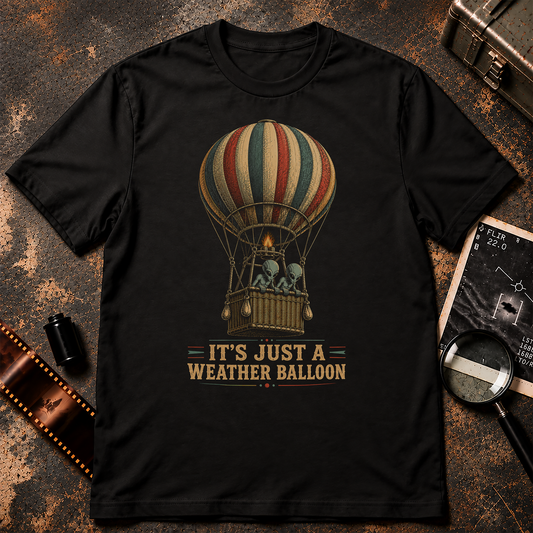 IT’S JUST A WEATHER BALLOON shirt design featuring two grey aliens riding in a vintage striped hot-air balloon, illustrated in a retro UFO and conspiracy style.