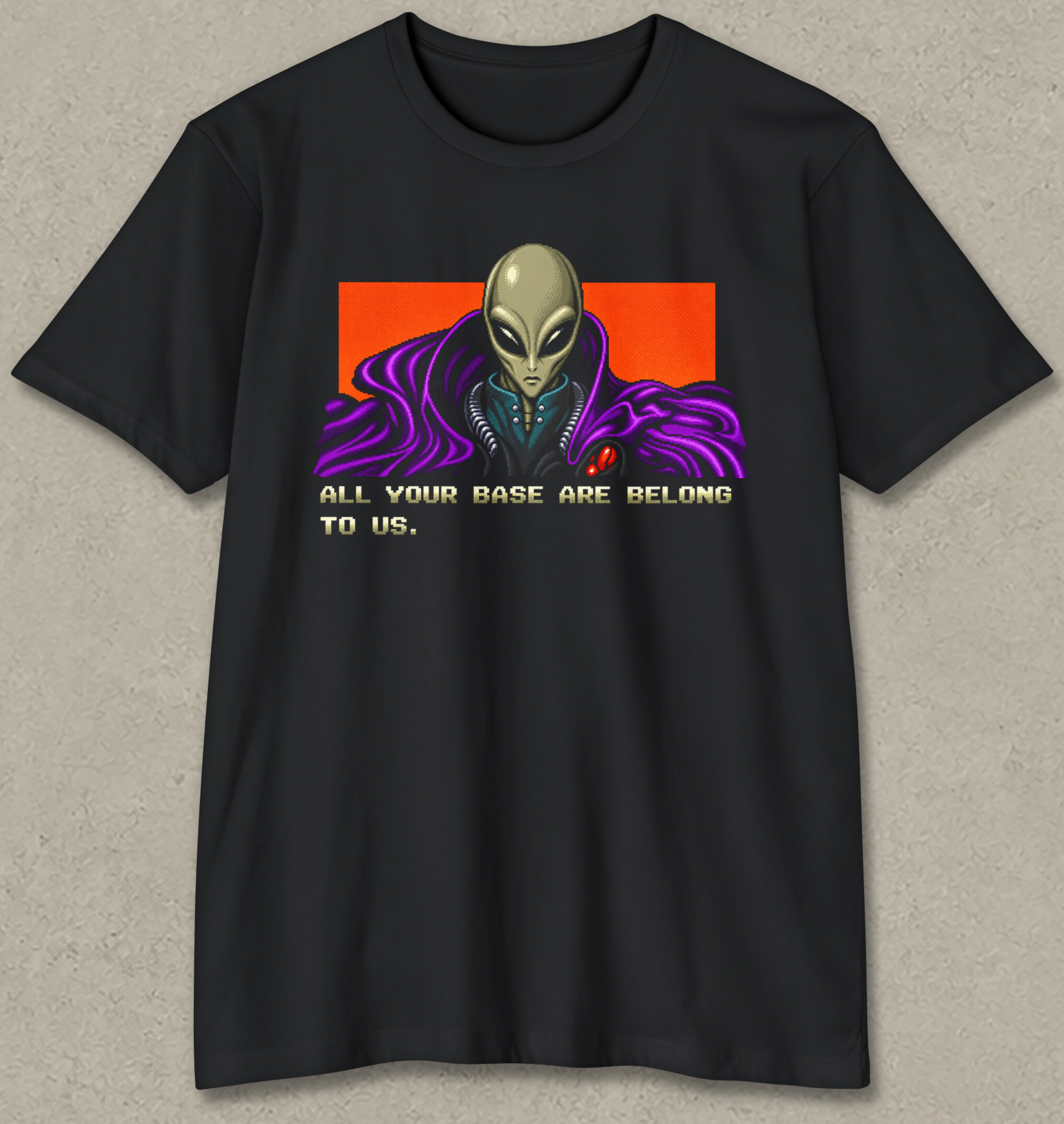 A black short-sleeve t-shirt with a retro sci-fi graphic of an alien in a purple cloak against an orange background, with the text 'ALL YOUR BASE ARE BELONG TO US.' printed below.